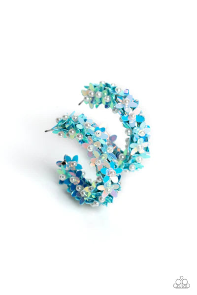 Paparazzi Accessories Fairy Fantasia - Blue A floral explosion, encompassing the entirety of a thick silver hoop, features reflective light blue flowers dotted with dainty pearl centers for a dreamy, whimsicality below the ear. Earring attaches to a stand