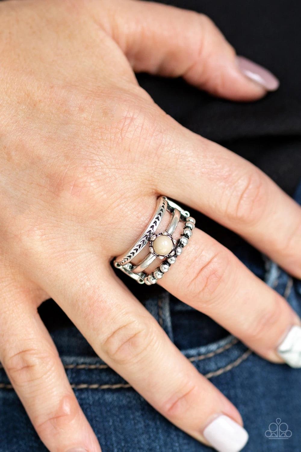 Paparazzi Accessories Pop Rival - Brown A trio of studded, smooth, and tribal stamped silver bands layer across the finger, coalescing into an airy frame. A dainty Soybean bead is pressed into the center of the shimmery layers for a perfect pop of color.