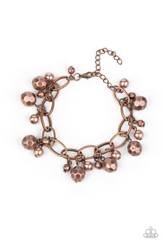 Paparazzi Accessories Make Do In Malibu - Copper Varying in size, a collection of faceted copper and pearly copper beads swings from a bold copper chain, creating a whimsical metallic fringe around the wrist. Features an adjustable clasp closure. Sold as