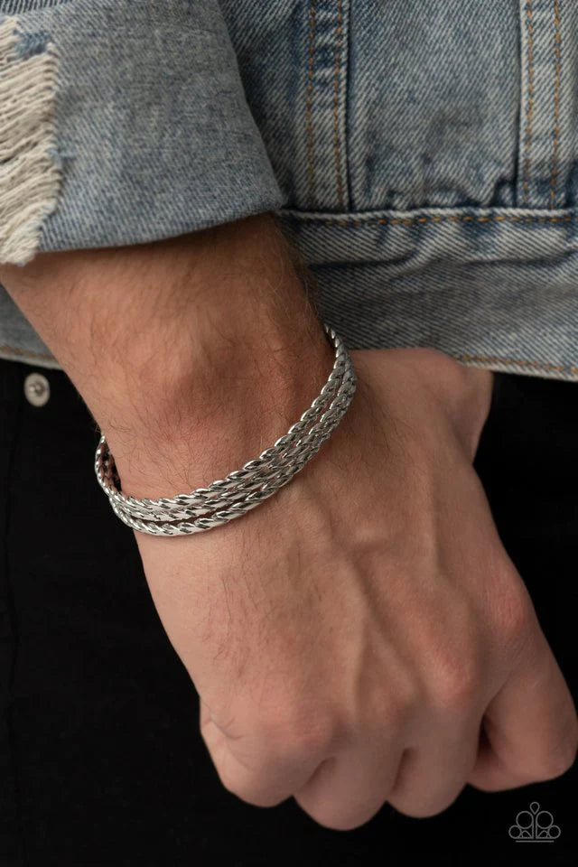 Paparazzi Accessories Line of Scrimmage - Silver Rows of flattened silver wires spin across the front of the wrist, coalescing into an edgy layered cuff. Jewelry