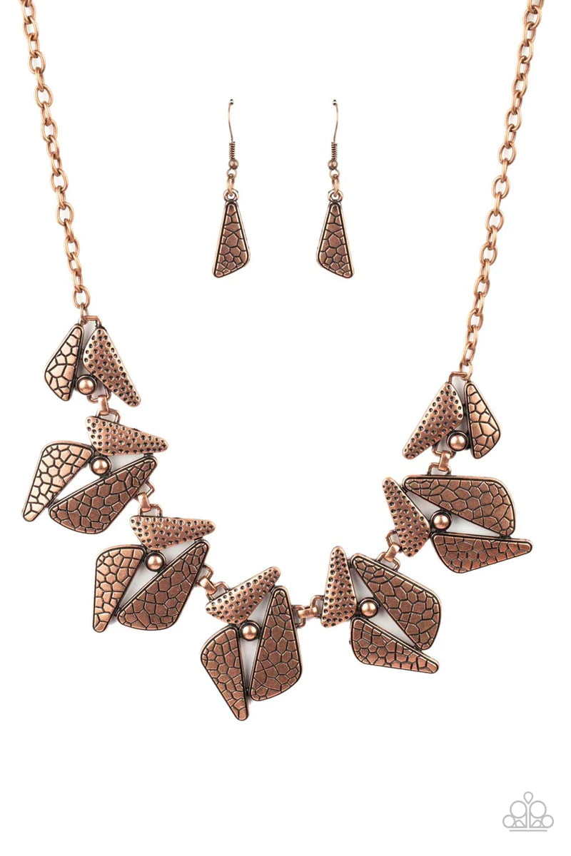 Paparazzi Accessories Extra Expedition - Copper Hammered and embossed in nature inspired patterns, mismatched triangular copper and studded frames delicately link below the collar for an adventurous look. Features an adjustable clasp closure. Sold as one