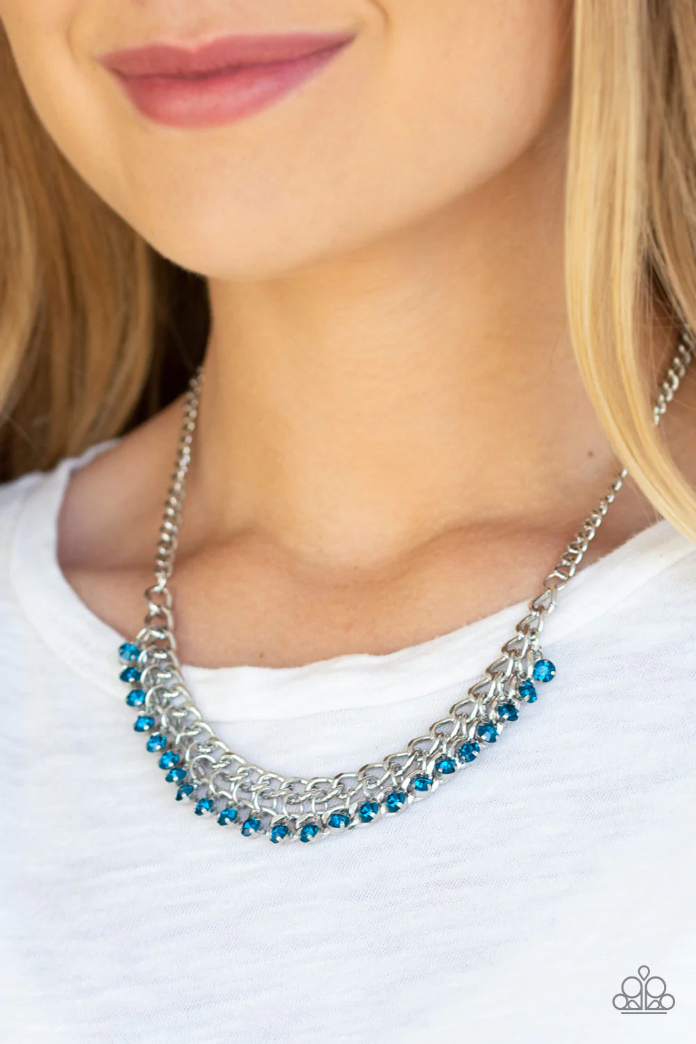 Paparazzi Accessories Glow and Grind - Blue A fringe of glittery blue rhinestones swings from the bottom of a bold silver chain below the collar for a fierce look. Features an adjustable clasp closure. Sold as one individual necklace. Includes one pair of