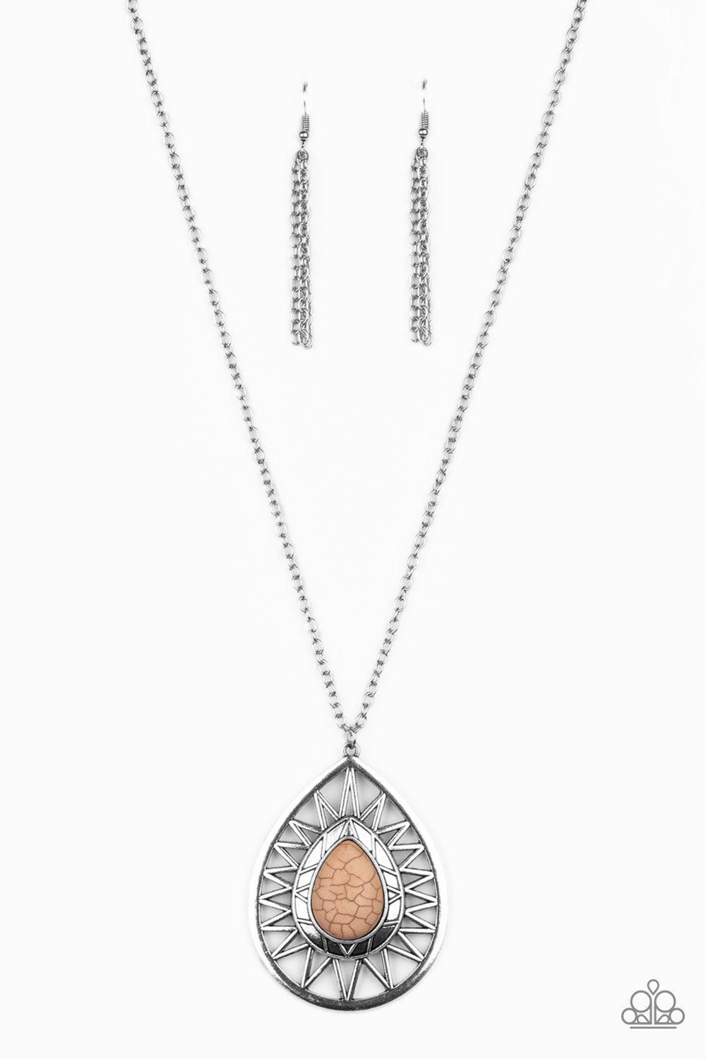 Paparazzi Accessories Summer Sunbeam - Brown An earthy brown stone is pressed into the center of a large silver teardrop radiating with shimmery sunburst patterns. The tribal inspired pendant swings from the bottom of a lengthened silver chain for a drama