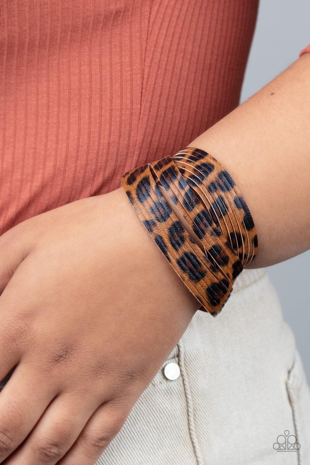 Paparazzi Accessories Hey GRRirl - Brown Painted in a lifelike brown and black cheetah print, thick leather bands have been spliced into layers that wave across the wrist for a wild look. Features an adjustable snap closure. Sold as one individual bracele
