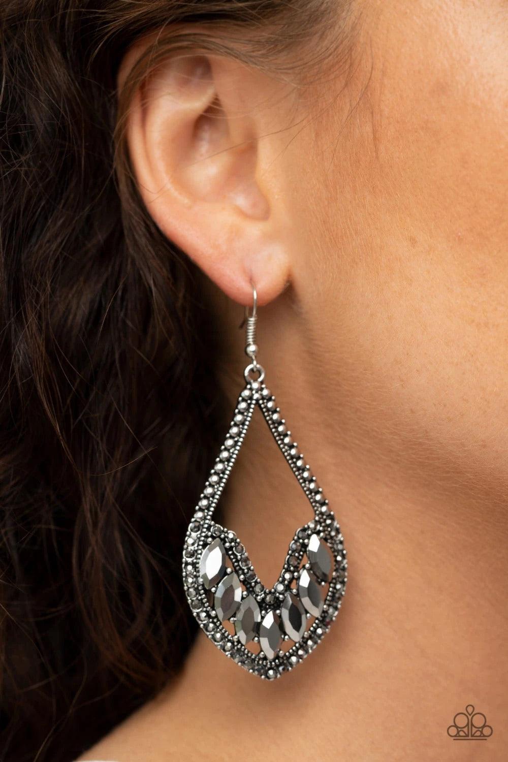 Paparazzi Accessories Ethereal Expressions - Silver Bordered in sections of dainty hematite rhinestones and antiqued silver studs, the bottom of an elongated silver teardrop is embellished in edgy marquise style hematite rhinestones for an epic finish. Ea