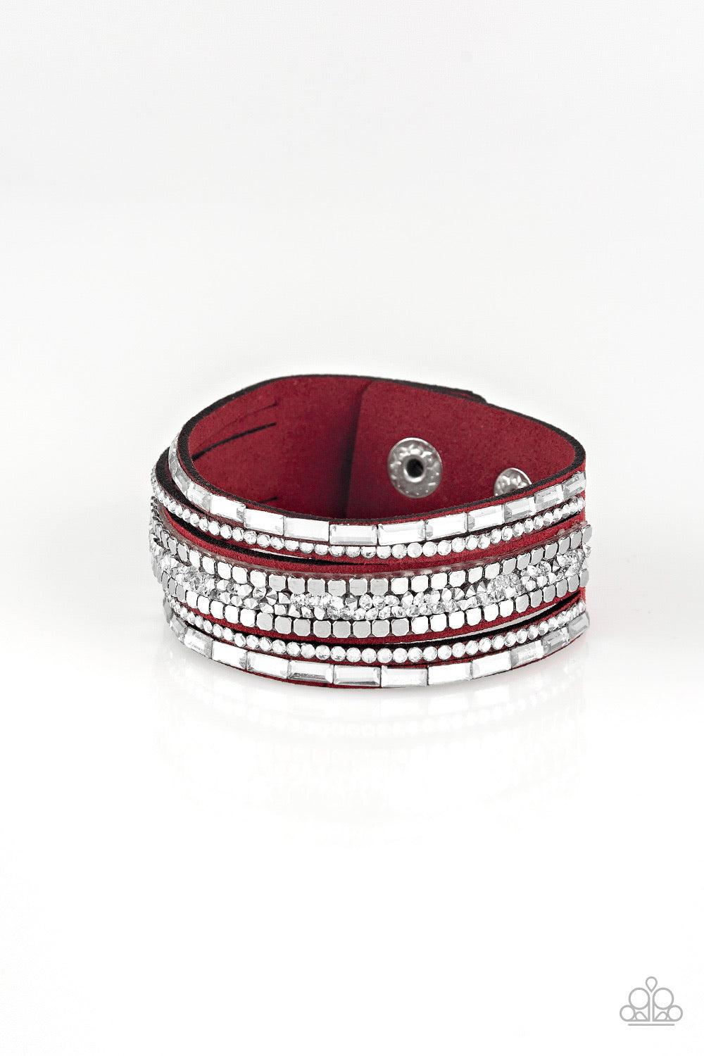 Paparazzi Accessories Rebel In Rhinestone - Red Featuring round and emerald style cuts, glassy white rhinestones join flat silver cubes and metallic prism rhinestones along a red suede band for a sassy look. Features an adjustable snap closure. Sold as on