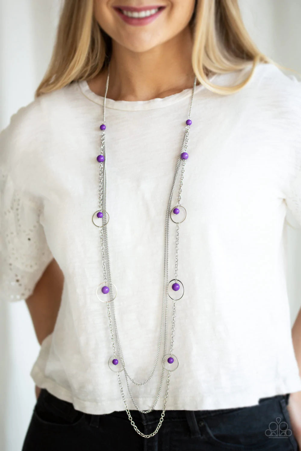 Paparazzi Accessories Collectively Carefree - Purple Infused with two plain strands of shimmery silver chains, polished purple beads and shimmery silver hoops trickle along a bold silver chain for a whimsically layered look. Features an adjustable clasp c