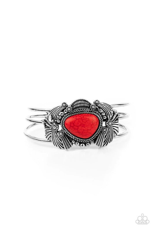 Paparazzi Accessories Western Wonderland - Red An asymmetrical red stone is pressed into the center of a rustic silver centerpiece stacked with flared silver frames, shiny studs, and antiqued floral accents. The whimsical frames sit atop a layered cuff, c