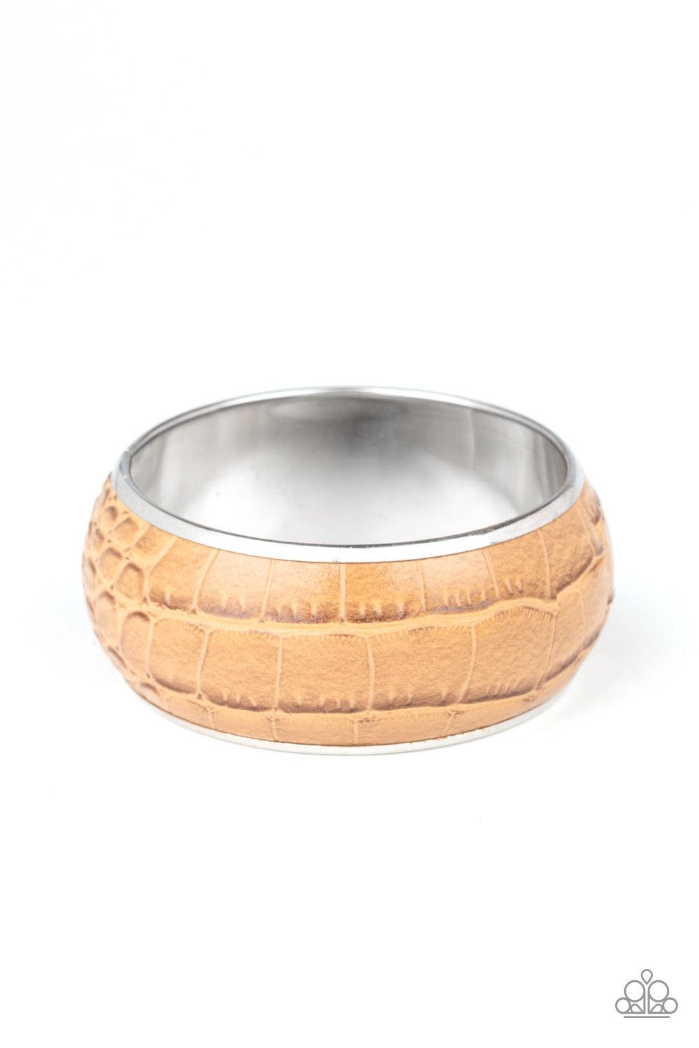 Paparazzi Accessories Urban Jungle - Brown Featuring a subtle crocodile print, a faux piece of tan leather wraps around a dramatically oversized silver bangle for a bold look. Jewelry