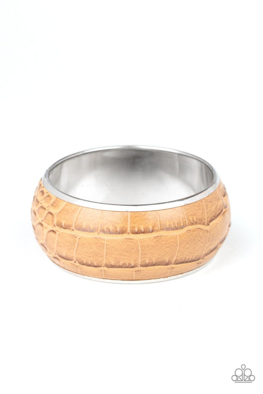 Paparazzi Accessories Urban Jungle - Brown Featuring a subtle crocodile print, a faux piece of tan leather wraps around a dramatically oversized silver bangle for a bold look. Jewelry