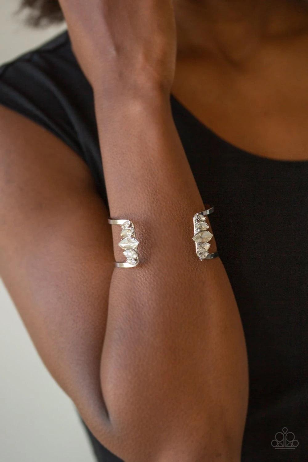 Paparazzi Accessories Glam Power - White Featuring regal marquise style cuts, an array of white rhinestones decorate the edges of an airy silver cuff for an edgy, glamorous finish. Sold as one individual bracelet. Jewelry