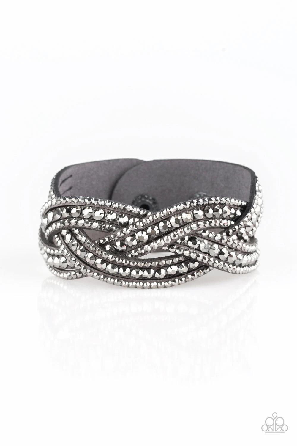 Paparazzi Accessories Bring on the Bling - Silver 2 Varying in size, glittery hematite rhinestones are encrusted along interwoven gray suede bands, creating blinding shimmer across the wrist. Features an adjustable snap closure. Sold as one individual bra
