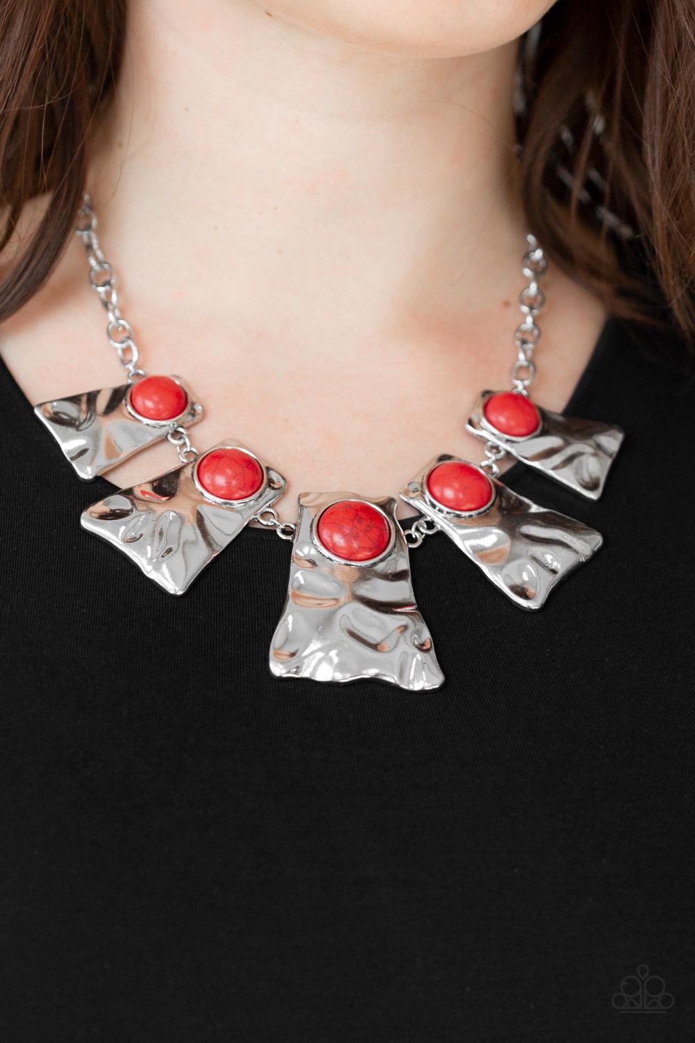 Paparazzi Accessories Cougar - Red Rippling with hammered details, flared silver frames join below the collar, creating a fierce fringe. Fiery red stones are pressed into the tops of the frames for a colorful finish. Features an adjustable clasp closure.