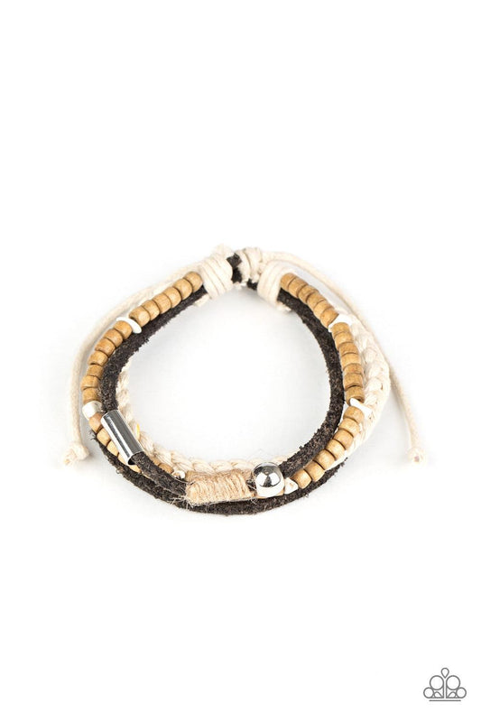 Paparazzi Accessories Sahara Pilgrim - Black Featuring silver, stone, and wooden beaded accents, a mismatched collection of suede and twine-like braided bands layer across the wrist for an earthy look. Features an adjustable sliding knot closure. Sold as