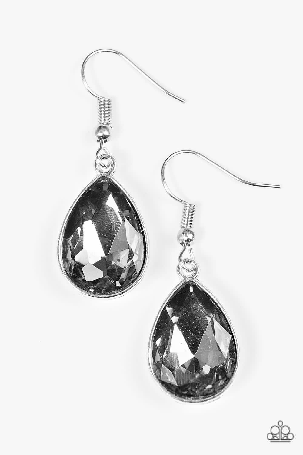 Paparazzi Accessories Play The FAME - Silver An oversized smoky rhinestone teardrop drips from the ear in a timeless fashion. Earring attaches to a standard fishhook fitting. Jewelry