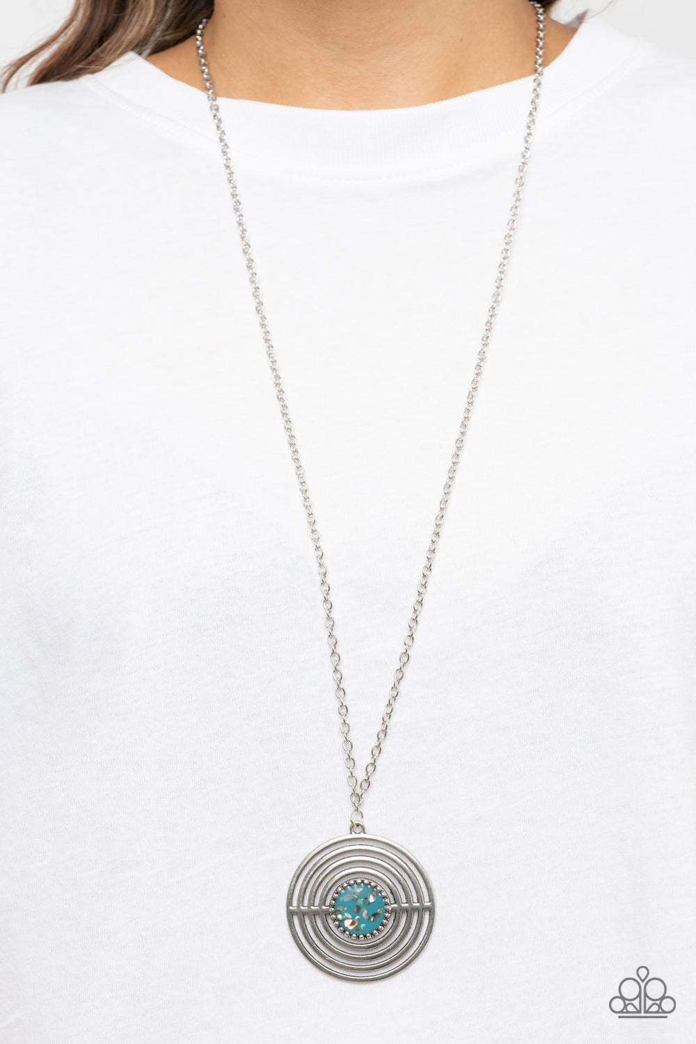 Paparazzi Accessories Targeted Tranquility - Blue Flecked in iridescent shell-like accents, a studded blue frame adorns the center of an oversized silver pendant rippling with concentric circles at the bottom of an extended silver chain for a dizzying pop