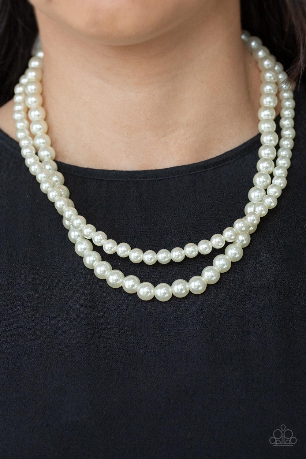 Paparazzi Accessories Woman of the Century ~White Two strands of classic white pearls are strung along invisible wires below the collar. Each strand slightly varies in size, adding a modern twist to the timeless pearl palette. Features an adjustable clasp