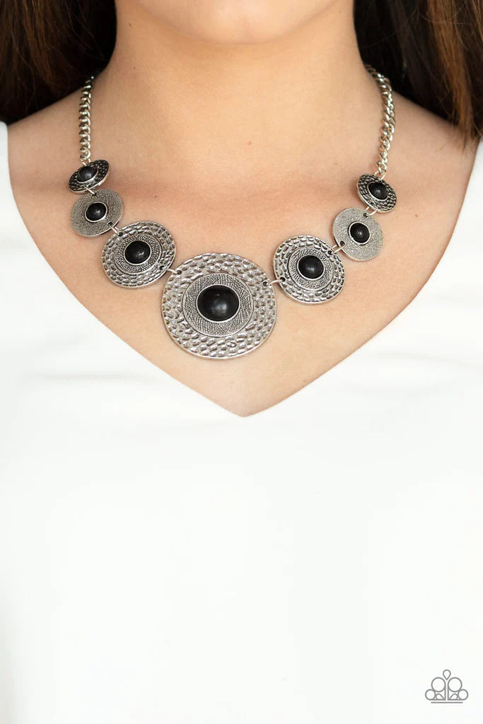 Paparazzi Accessories Tiger Trap - Black Dotted with smooth black stone centers, mismatched hammered silver frames gradually increase in size as they link below the collar for a fierce look. Features an adjustable clasp closure Jewelry