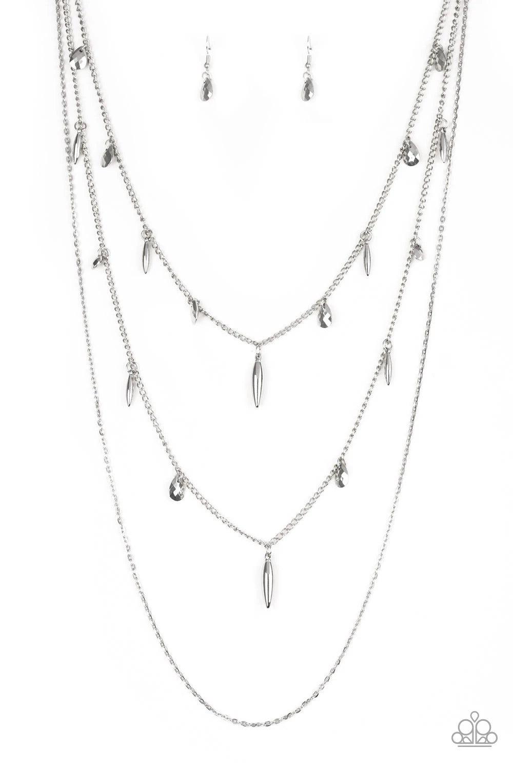 Paparazzi Accessories Bravo Bravado - Silver Mismatched silver chains layer down the chest. Faceted silver teardrops and shiny silver accents swing from two of the shimmery silver chains for an edgy finish. Features an adjustable clasp closure. Sold as on
