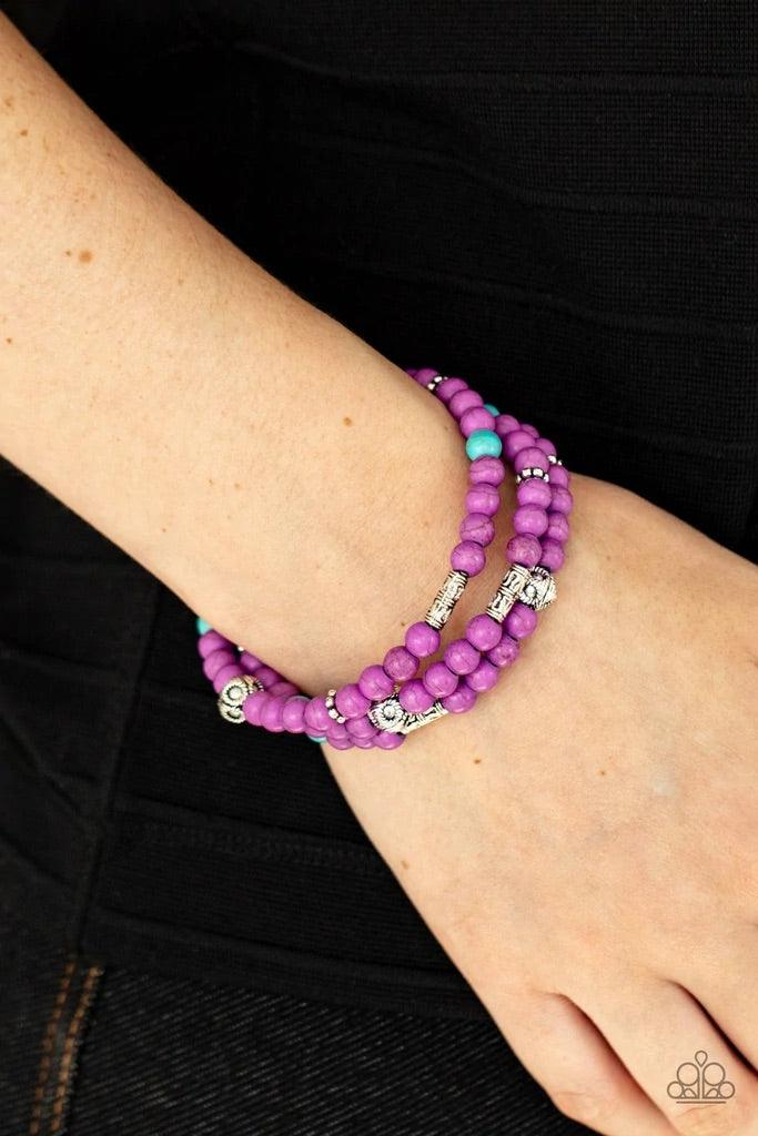 Paparazzi Accessories Desert Decorum - Purple A collection of purple and turquoise stone beads, silver cube beads, and ornate silver accents are threaded along invisible bands around the wrist, creating vivacious layers. Features an adjustable clasp closu