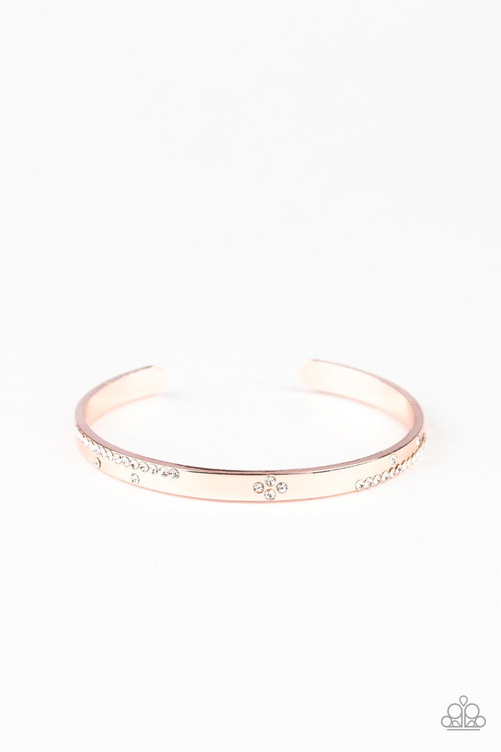 Paparazzi Accessories Dainty Dazzle - Rose Gold Glassy white rhinestones are sprinkled across the front of a dainty rose gold cuff for a refined look. Jewelry
