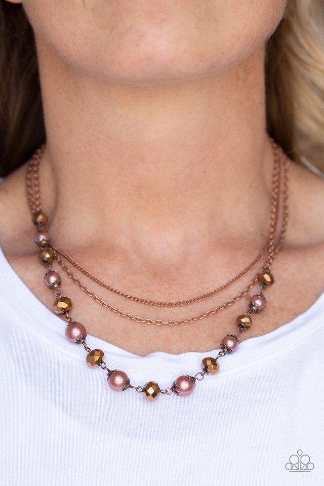 Paparazzi Accessories Tour de Demure - Copper Infused with two layers of dainty copper chains, pearly copper beads and coppery aurum rhinestones link below the collar for a demure look. Features an adjustable clasp closure. Sold as one individual necklace