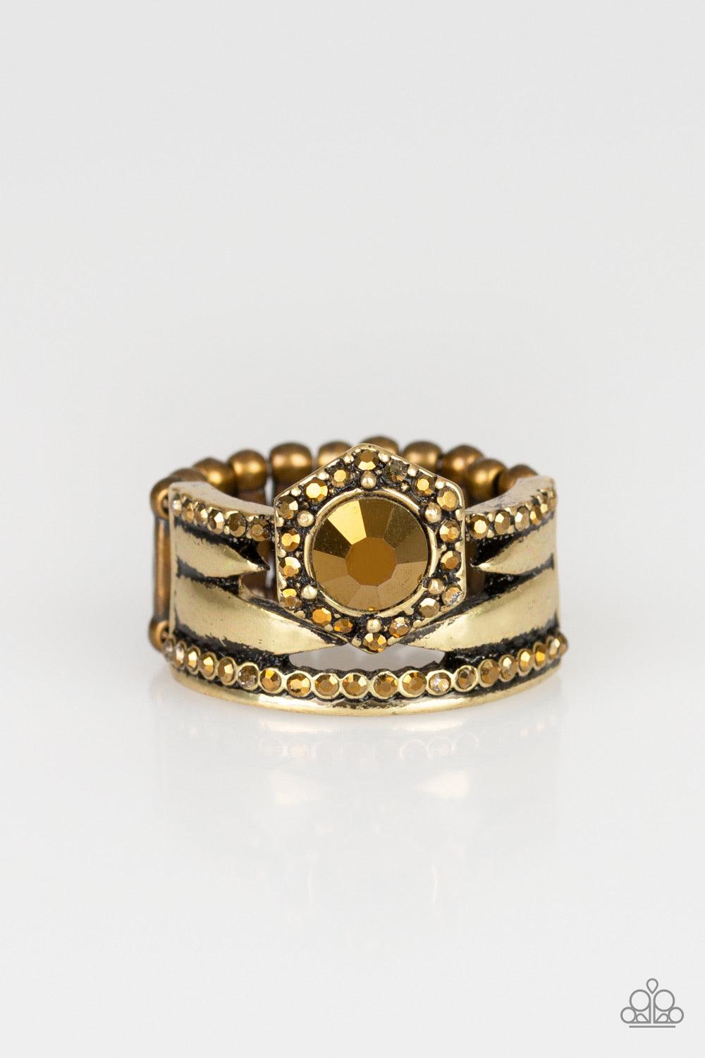 Paparazzi Accessories Modern Maven - Brass A collision of glistening brass bands and aurum rhinestone encrusted bands stack across the finger. Featuring a glittery aurum rhinestone center, a brass hexagon frame crowns the top of the layered bands for an e