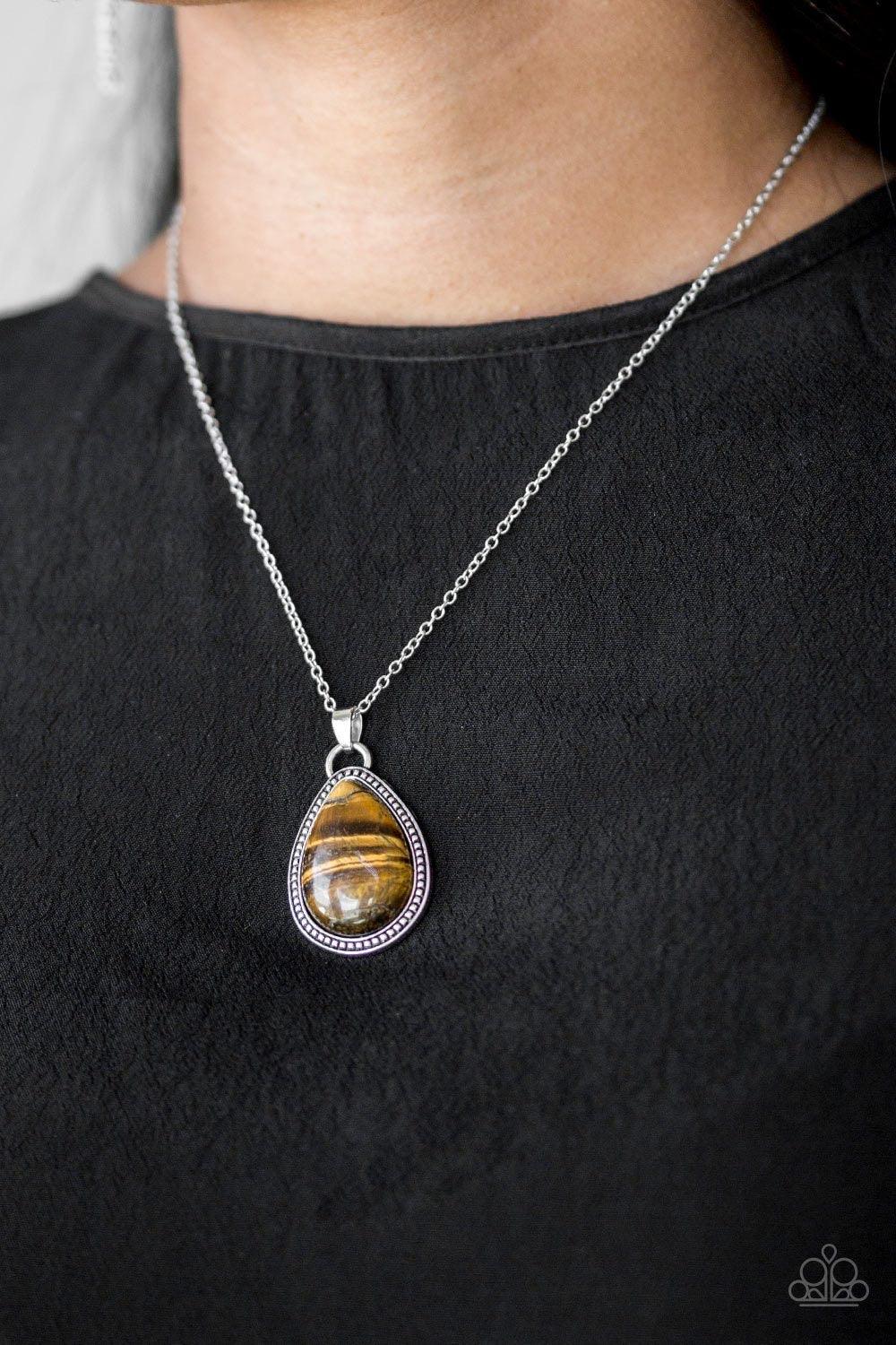 Paparazzi Accessories On The Home FRONTIER - Brown A teardrop tiger's eye stone is pressed into a studded silver frame, creating a tranquil pendant below the collar. Features an adjustable clasp closure. Jewelry