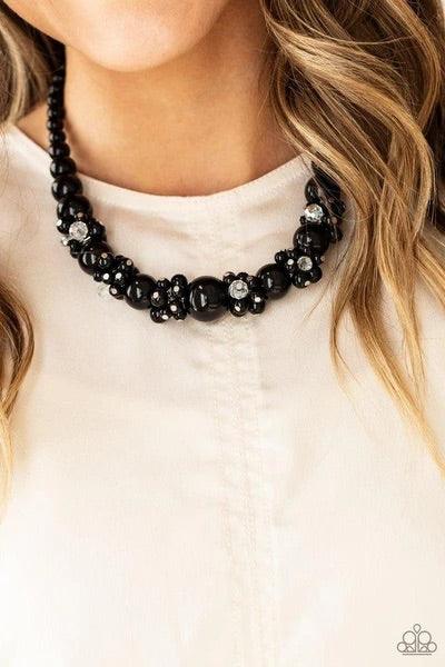 Paparazzi Accessories All Dolled UPSCALE - Black Dainty black beads and sparkly white crystal-like beads cluster between oversized black beads that are threaded along an invisible wire below the collar, creating a stunning centerpiece. Features an adjusta