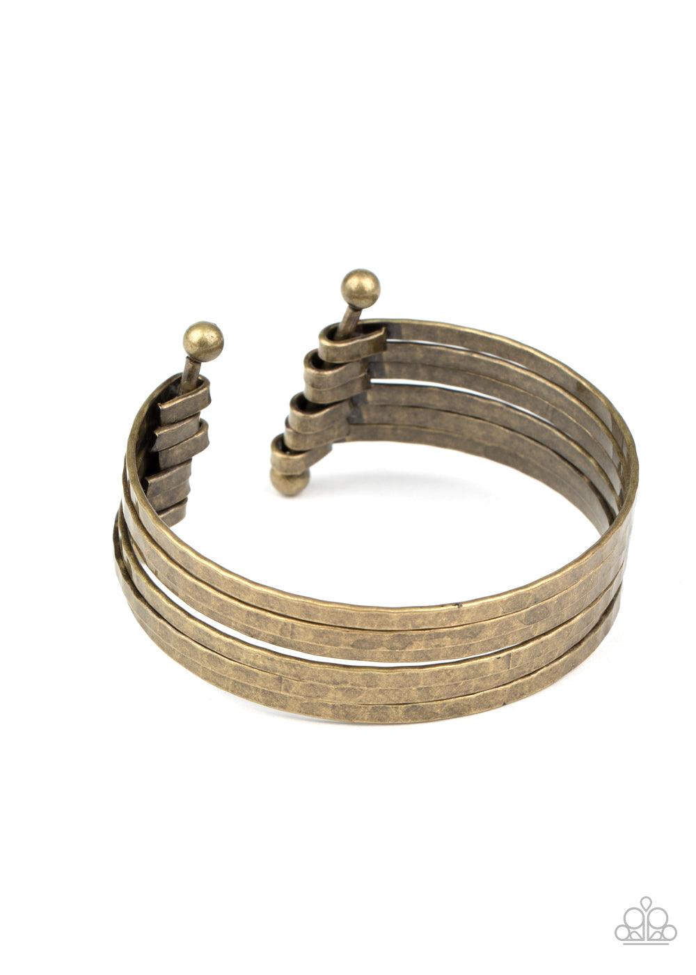 Paparazzi Accessories BAUBLE-Headed - Brass Brushed in an antiqued shimmer, hammered brass bars arc across the wrist. The flattened bars connect to two rod fittings, creating a trendy layered cuff. Sold as one individual bracelet. Jewelry