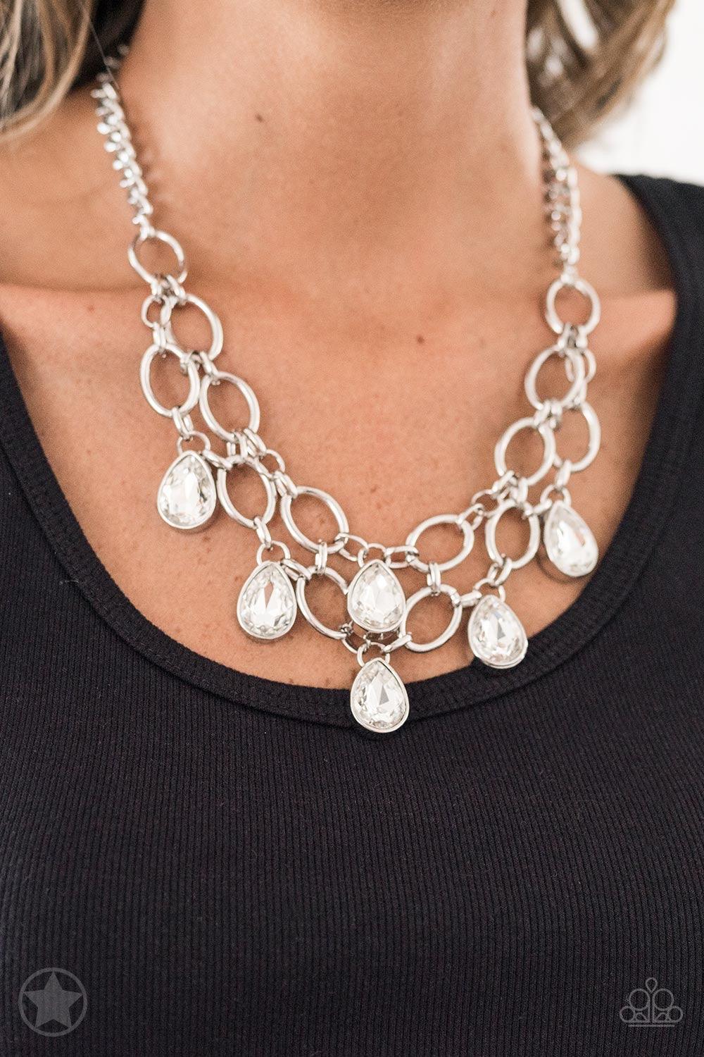 Paparazzi Accessories Show-Stopping Shimmer - White Joined by dainty silver links, two rows of dramatic silver chain layer below the collar in a fierce fashion. Glittery white teardrops drip from the glistening layers, adding a timeless shimmer to the sho