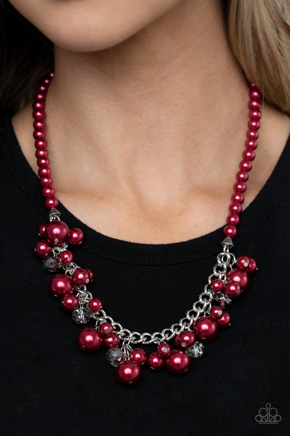 Paparazzi Accessories Prim And POLISHED - Red Threaded along an invisible wire, a pearly strand of red beads gives way to a section of chunky silver chain below the collar. Clusters of pearly red beads and smoky metallic-flecked crystals swing from the ch