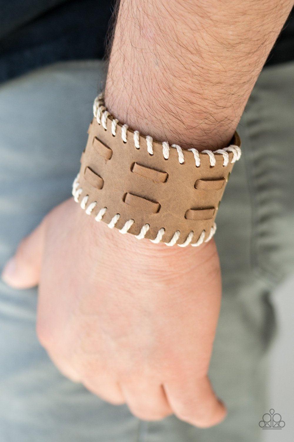 Paparazzi Accessories West RIDE Story - Brown Suede laces are threaded down the center of a thick brown suede band. Earthy twine is stitched down the edges of the band, adding a rustic finish to the urban palette. Features an adjustable snap closure. Sold