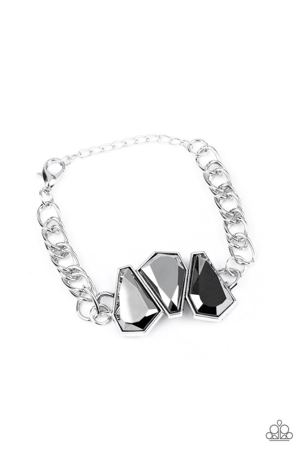 Paparazzi Accessories Raw Radiance - Silver Attached to a shiny silver chain, a trio of sparkly hematite gem-shaped rhinestones join into a glamorous centerpiece atop the wrist. Features an adjustable clasp closure. Sold as one individual bracelet. Jewelr
