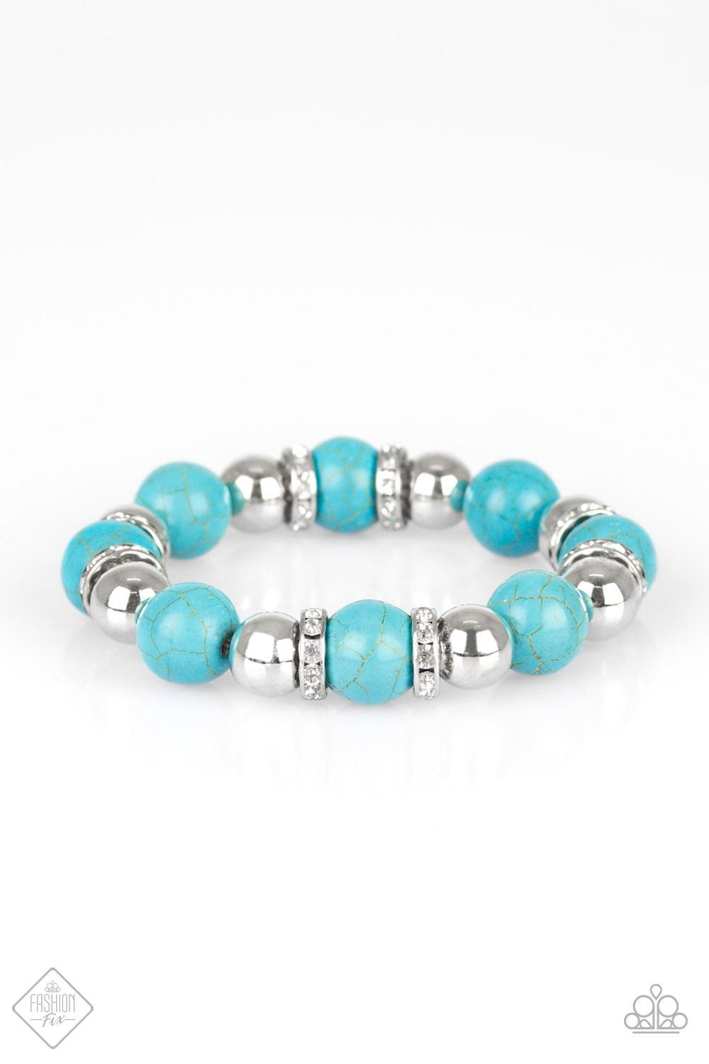 Paparazzi Accessories Ruling Class Radiance - Blue Faux turquoise stones, shiny silver beads, and white rhinestone encrusted rings are threaded along a stretchy band and wrapped around the wrist for an elegantly earthy finish. Jewelry