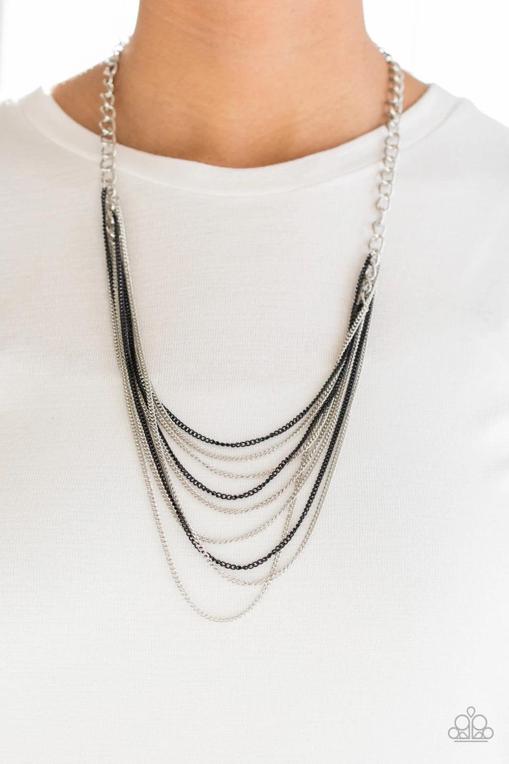 Paparazzi Accessories Rebel Rainbow - Black Strands of bold silver links give way to rows of shimmery silver and shiny black chains, creating colorful layers down the chest. Features an adjustable clasp closure. Sold as one individual necklace. Includes o