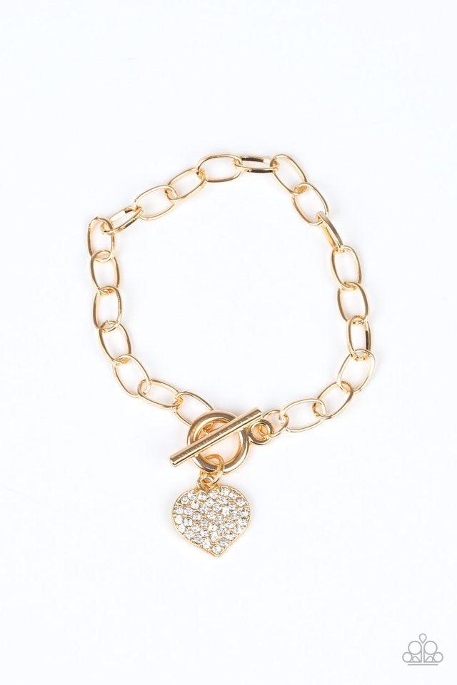 Paparazzi Accessories Lots of Love - Gold Radiating with glassy white rhinestones, a glittery gold heart charm swings from a glistening gold chain for a flirtatious look. Features a toggle closure. Jewelry