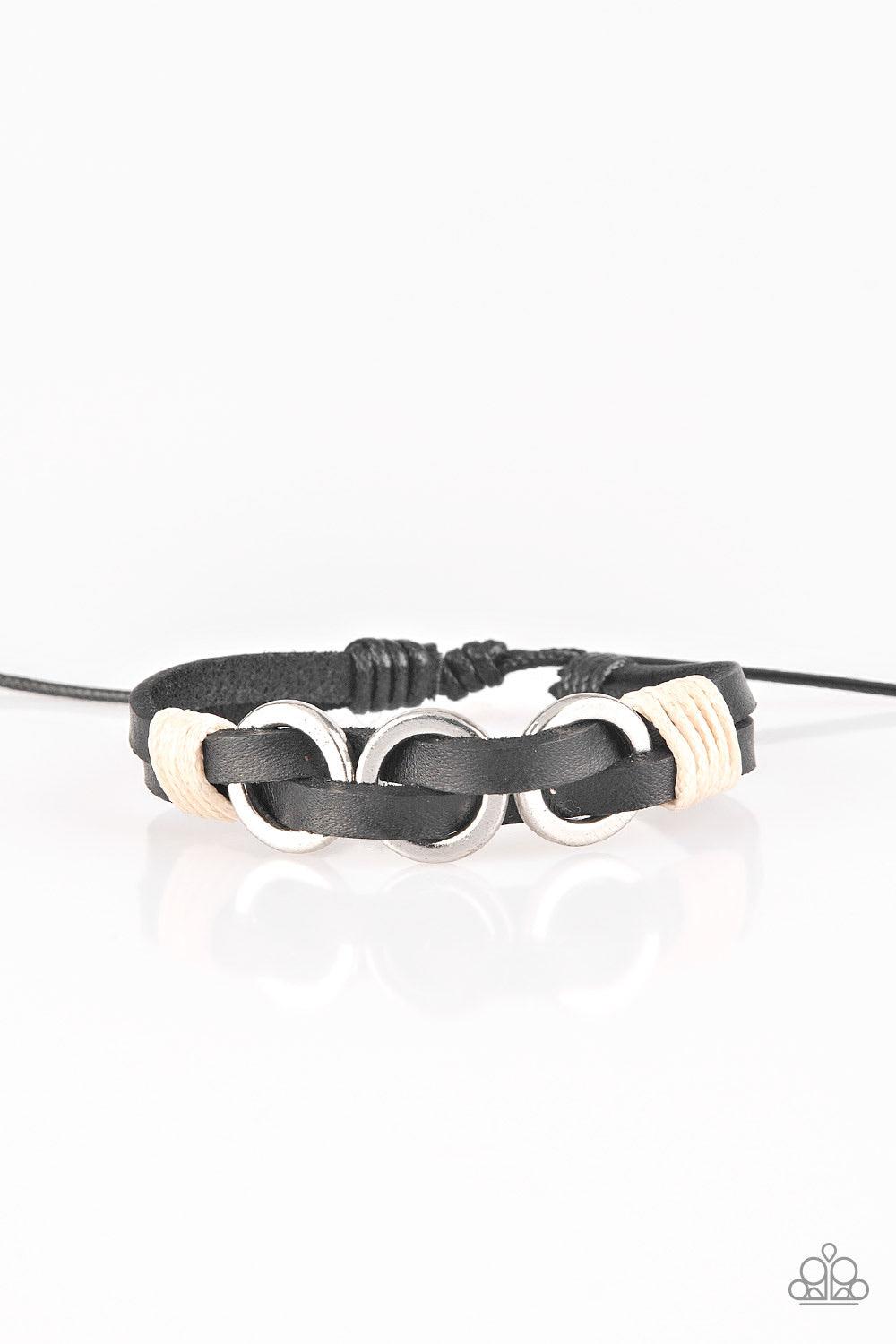 Paparazzi Accessories Off-Road Tourist - Black Infused with white twine cording, antiqued silver rings are threaded along strands of black leather bands for a rustic look. Features an adjustable sliding knot closure. Jewelry Sets