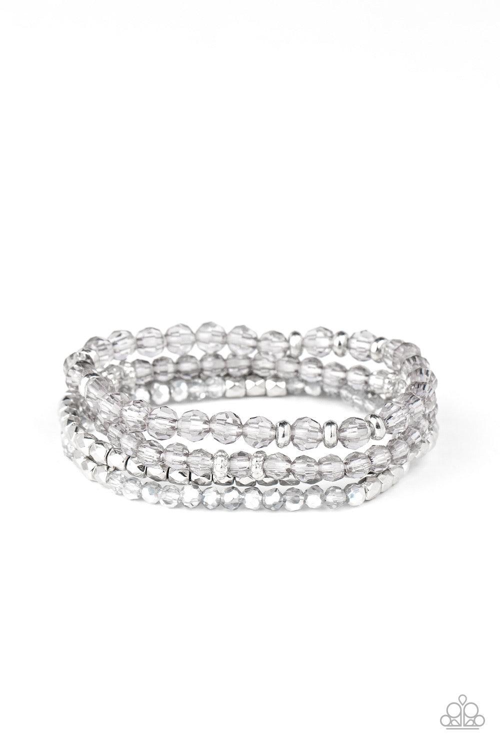 Paparazzi Accessories Crystal Crush - Silver A glittery collection of faceted silver beads and smoky and metallic flecked crystal-like beads are threaded along stretchy bands around the wrist, creating sparkly layers. Sold as one set of three bracelets. J