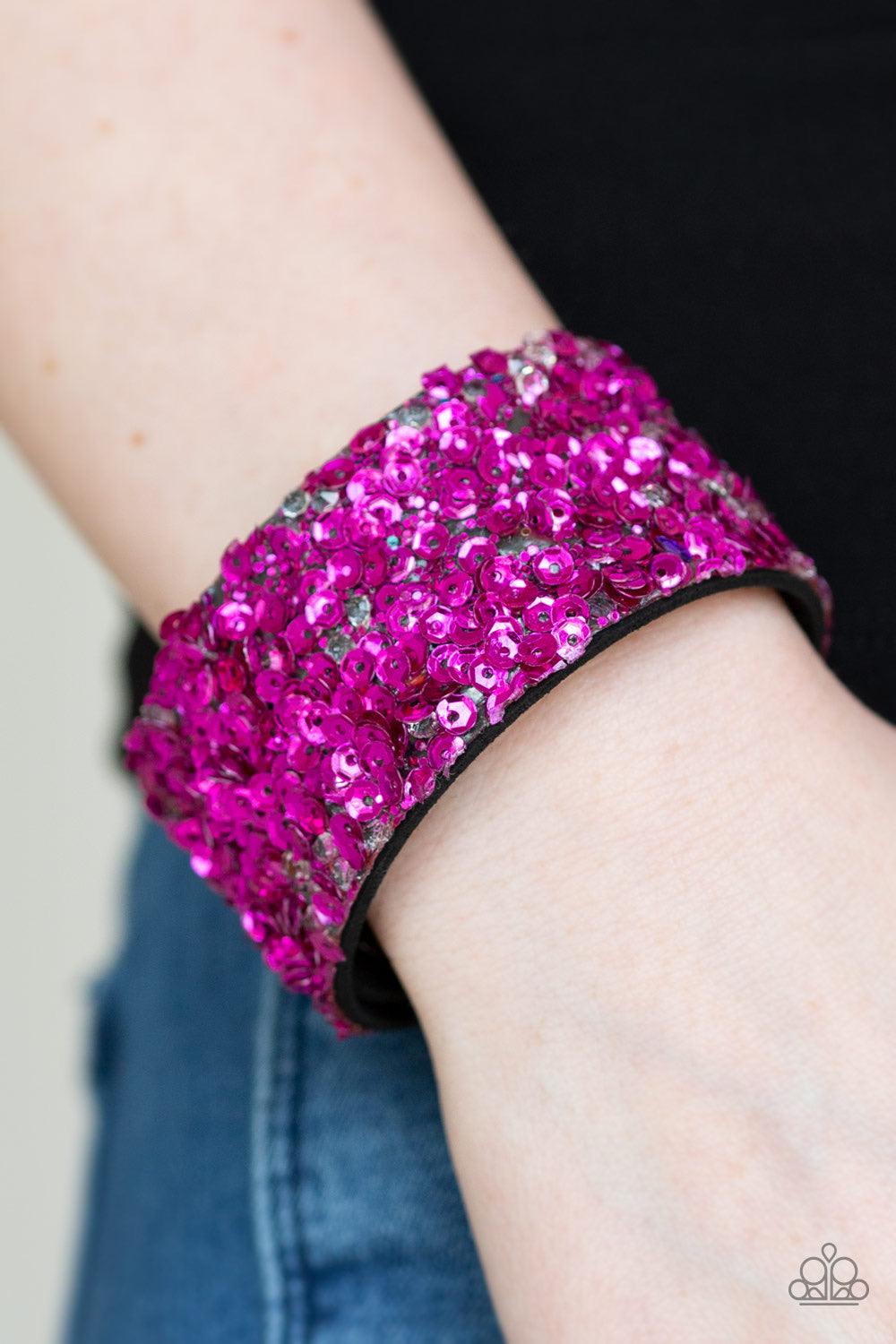 Paparazzi Accessories Starry Sequins - Pink A collision of glittery rhinestones and sparkling pink sequins are encrusted along the front of a black suede band, creating blinding shimmer around the wrist. Features an adjustable snap closure. Jewelry