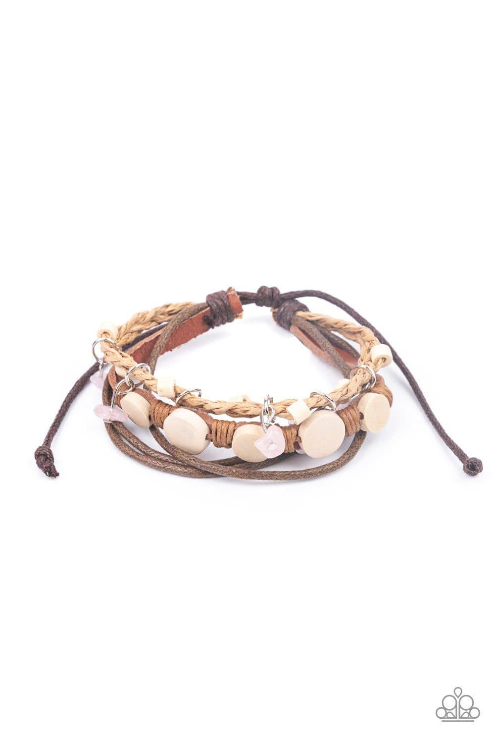 Paparazzi Accessories Run The Rapids - Pink Assorted strands of cording and leather, featuring flat wooden beads and small pink polished stones dangling from silver fittings, layer across the wrist for an earthy handcrafted style. Features an adjustable s
