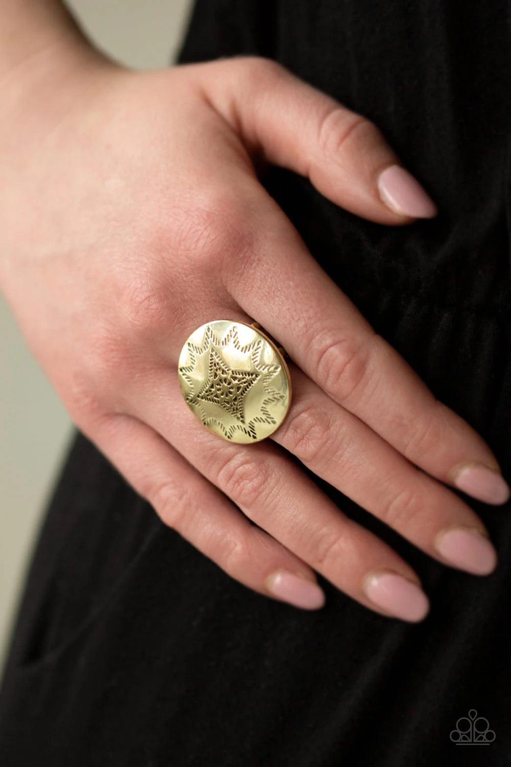 Paparazzi Accessories Rural Radius - Brass Dotted in a radiant sunburst pattern, a shiny brass frame spins atop the finger for a seasonal look. Features a stretchy band for a flexible fit. Jewelry