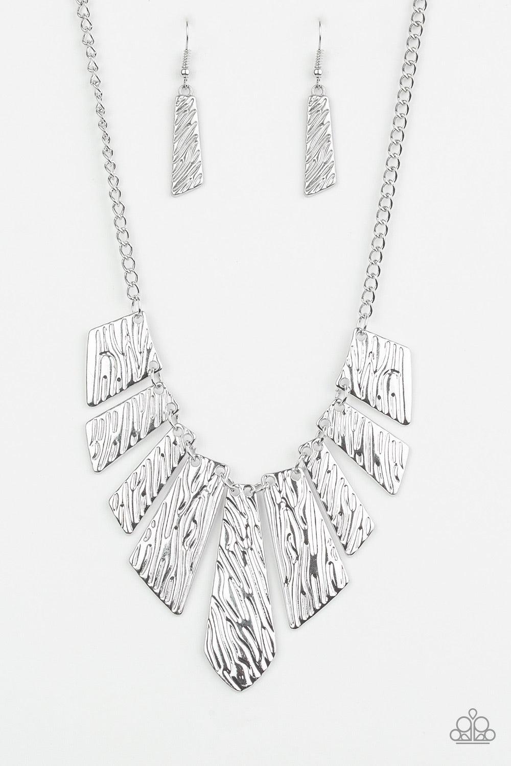 Paparazzi Accessories Texture Tigress - Silver Embossed in rippling patterns, a collection of angular silver plates swing from the bottom of a glistening silver chain, creating an edgy geometric fringe below the collar. Features an adjustable clasp closur