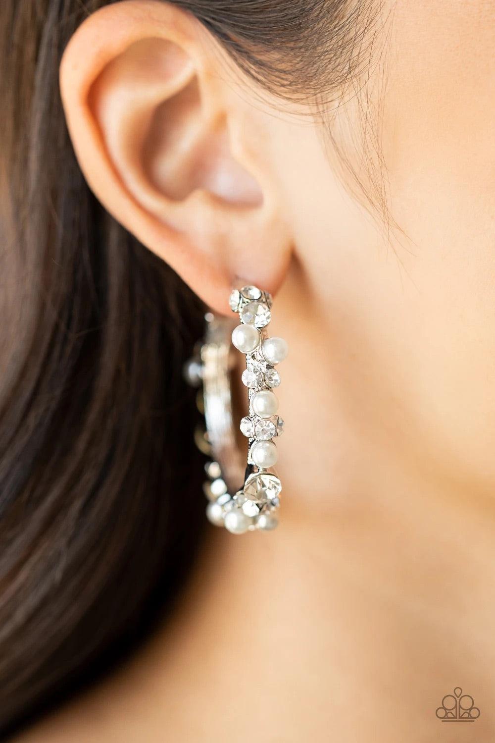 Paparazzi Accessories Let There Be Socialite - White A bubbly array of classic white rhinestones and glassy white rhinestones are encrusted along the front of a silver hoop, creating an elegantly effervescent look. Earring attaches to a standard post fitt