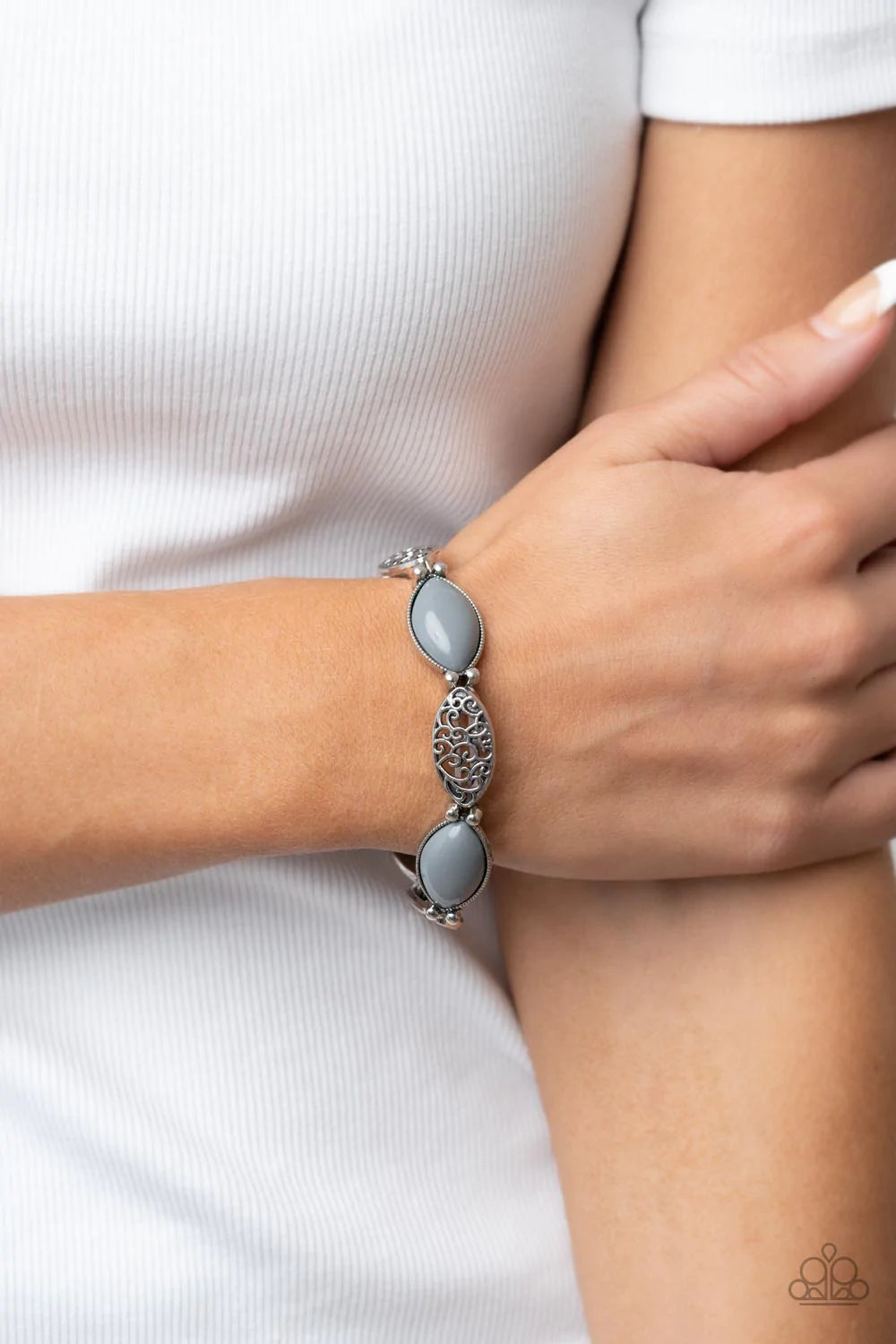 Paparazzi Accessories Garden Rendezvous - Silver Ultimate Gray beads, set in daintily studded silver frames, mingle with frames of swirling silver filigree as they alternate along stretchy bands for a whimsically wild fashion around the wrist. Sold as one