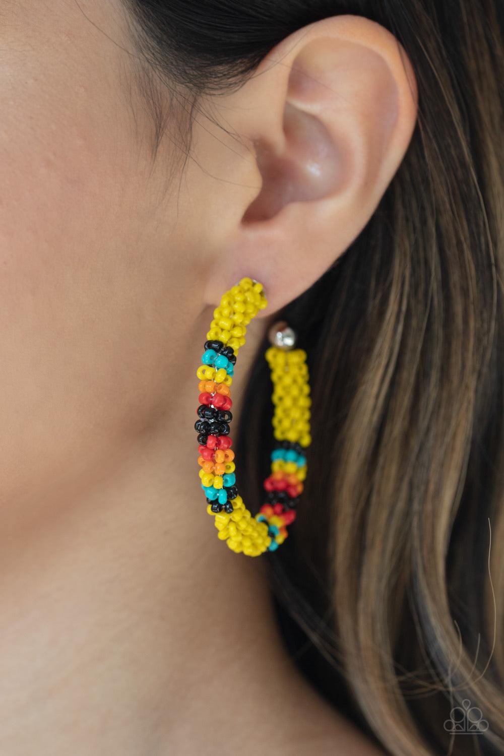 Paparazzi Accessories Bodaciously Beaded - Yellow A colorful strand of yellow, black, blue, red, and orange seed beads wraps around a shiny silver hoop, creating a colorfully seasonal look. Earring attaches to a standard post fitting. Hoop measures approx