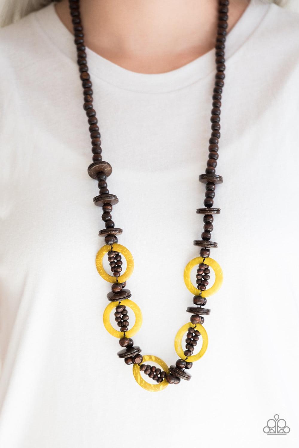 Paparazzi Accessories Fiji Foxtrot - Yellow Mismatched brown wooden beads are threaded along a brown cord for an earthy look. Sunny yellow wooden discs connect with beaded links across the chest for a summery finish. Jewelry