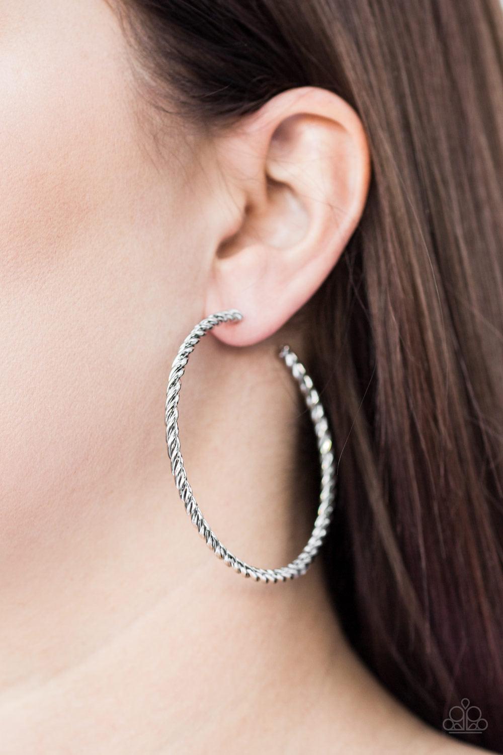 Paparazzi Accessories Keep It Chic - Silver A twisted shiny silver hoop curls around the ear for a casual look. Earring attaches to a standard post fitting. Hoop measures 2 1/4" in diameter. Sold as one pair of hoop earrings. Jewelry