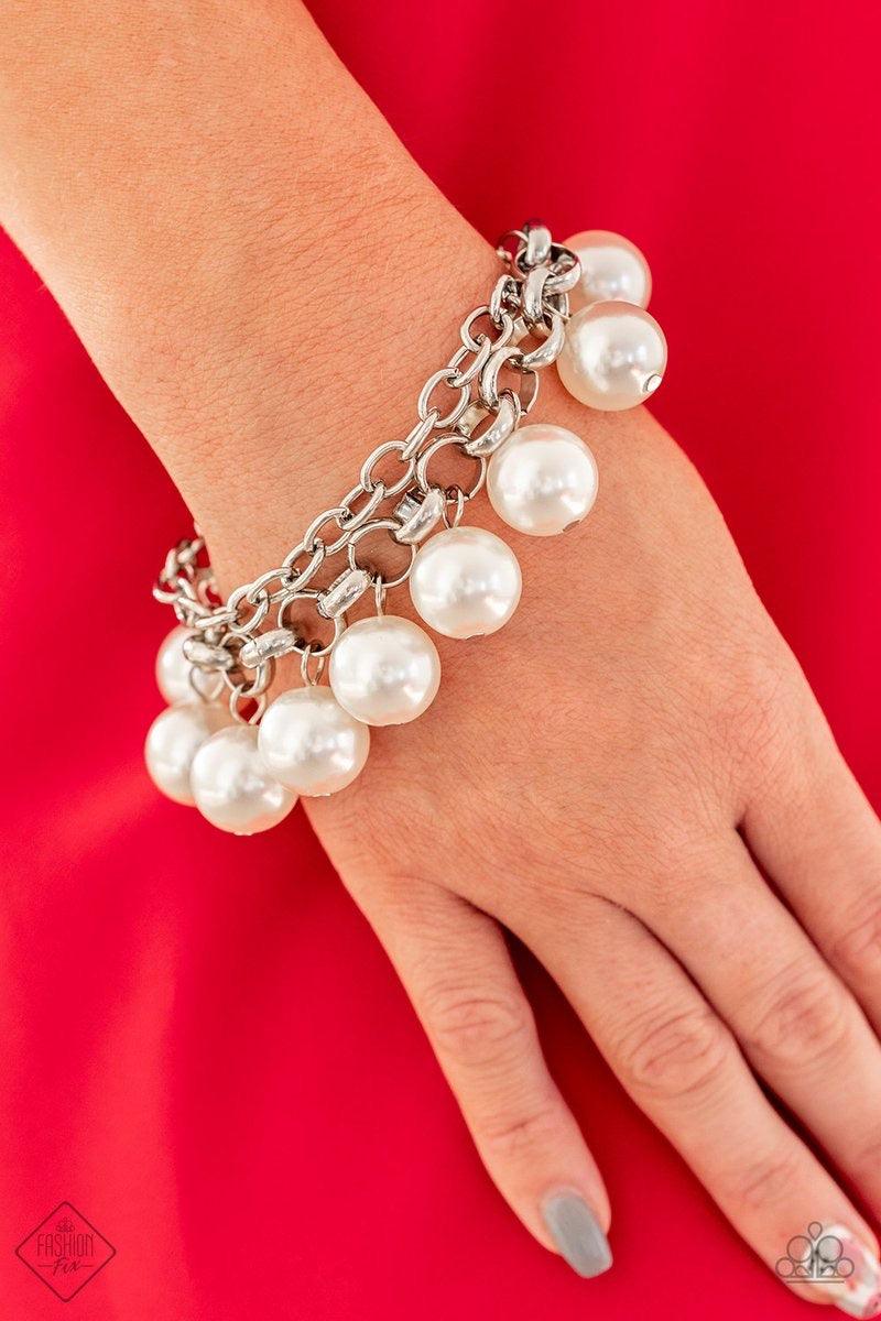 Paparazzi Accessories One-Way Wallstreet ~White A simple square-link chain runs parallel with a chunky silver chain that has been decorated in over sized white pearls that dangle from the wrist, creating a dramatic fringe. Features an adjustable clasp clo