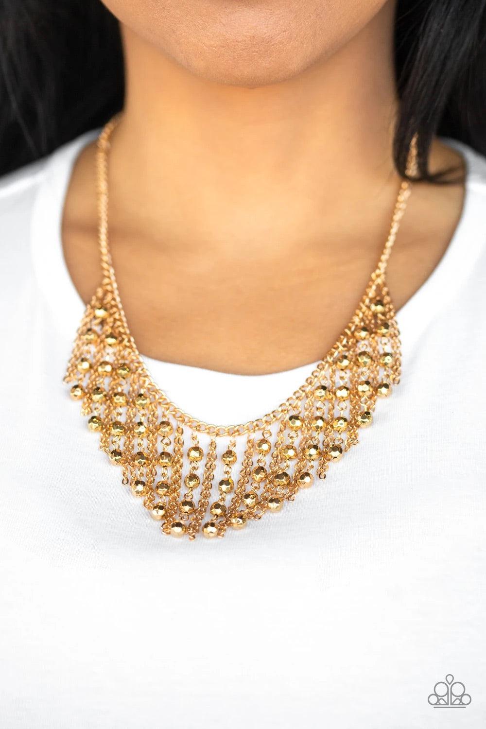 Paparazzi Accessories Rebel Remix - Gold Stands of faceted gold beads and glistening gold chains stream from a matching gold chain, creating an edgy fringe below the collar. Features an adjustable clasp closure. Sold as one individual necklace. Includes o